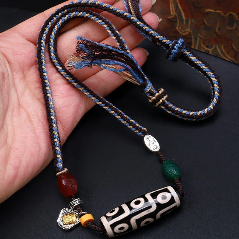 Tibetan nine-eye Dzi bead cord pendant — view 1