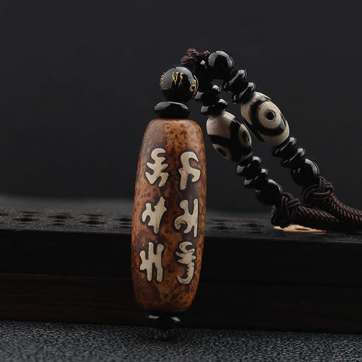 Tibetan Dzi bead Avalokiteshvara pendant — view 1