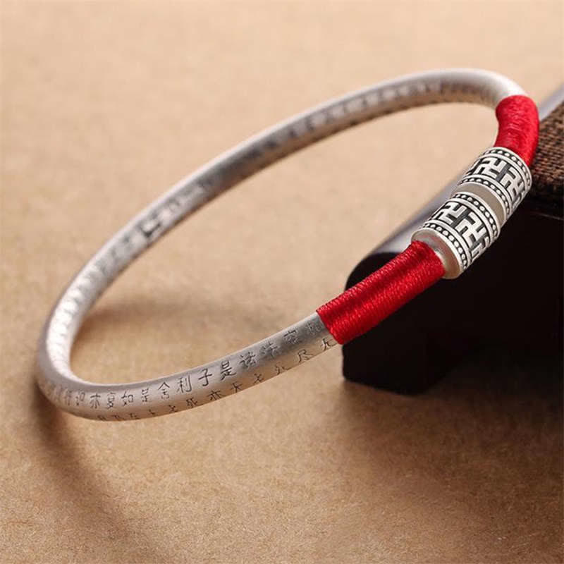 Tibetan mantra red string bangle — view 1